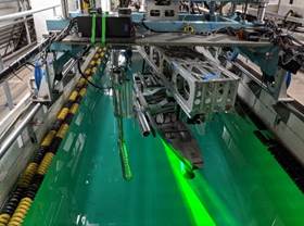 A machine with green liquid in it

Description automatically generated